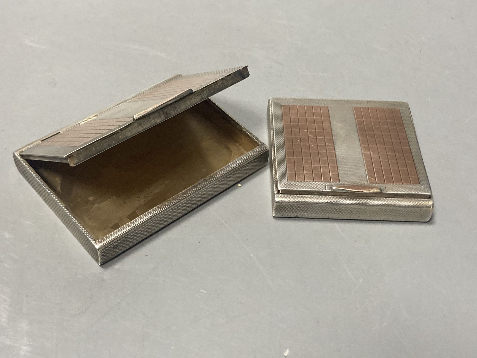 An early 1950s cased engine turned silver and yellow metal cigarette case and matching compact,